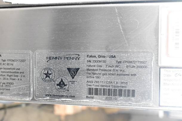 Brand new Henny Penny FPGM22172007 stainless steel commercial convection oven, natural gas, 200,000 BTU. Tags show model details and certifications.