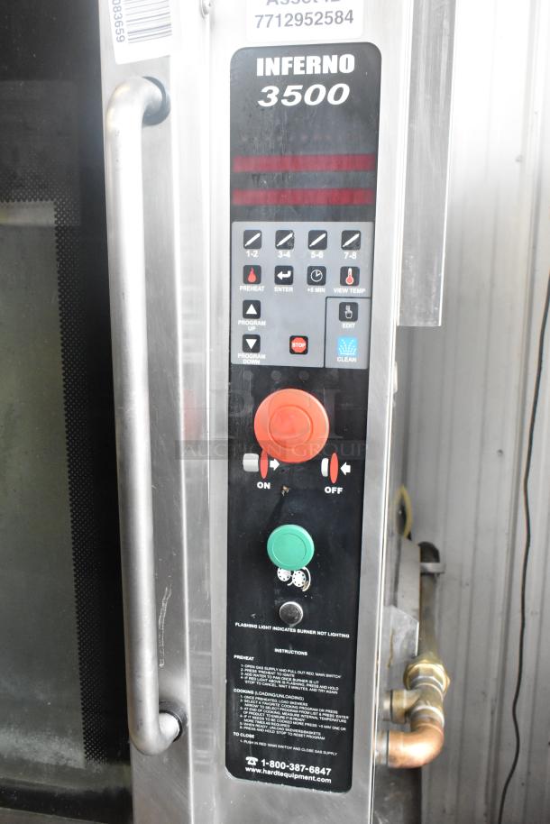 Hardt Inferno 4500 stainless steel rotisserie oven with control panel, skewers, metal legs, and commercial casters. Model 3500 label visible.