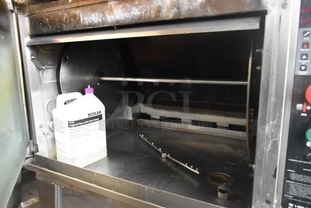 Hardt Inferno 4500 stainless steel rotisserie oven, natural gas-powered, with skewers and casters. Includes Ecolab oven cleaner.