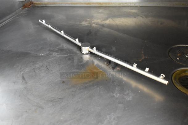 Hardt Inferno 4500 stainless steel commercial rotisserie oven interior and skewer mount, showcasing slight wear.