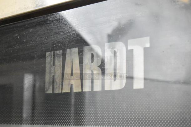 Alt text: Hardt Inferno 4500 stainless steel rotisserie oven, natural gas, with skewers, metal legs, commercial casters.