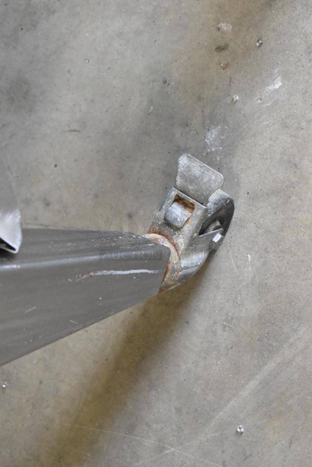 Worn caster wheel on a Hardt Inferno 4500 rotisserie oven's stainless steel leg, showing signs of use.