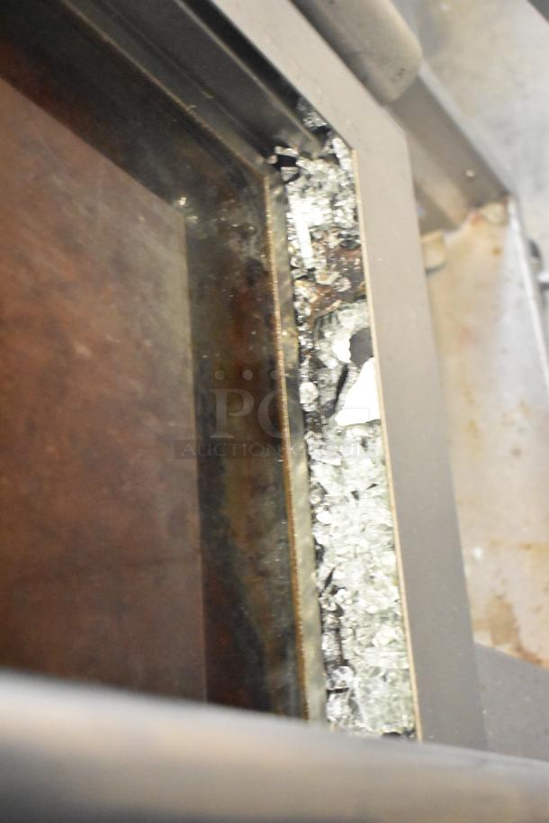 Baxter OV310G stainless steel mini rotating rack oven, damaged glass, right door non-functional, on double pan rack with casters.