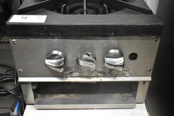 Stainless steel commercial countertop gas single burner stock pot range with control knobs. Used condition. Item tag reads "12 QTY 1".