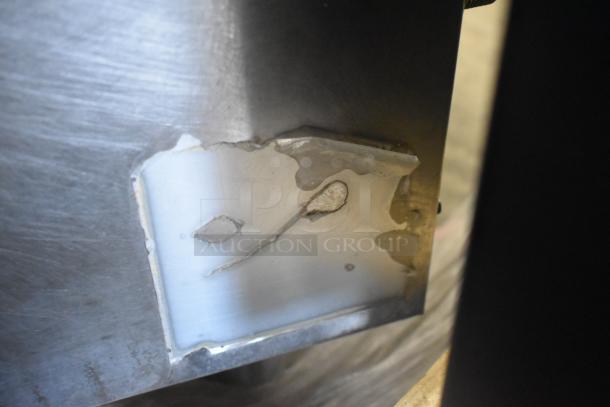 A damaged section of an Atosa stainless steel commercial countertop single burner stock pot range, showing rust and corrosion.