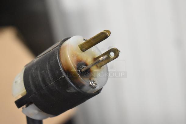 Close-up of the power plug for the 2017 Manitowoc IR0520A-161 stainless steel commercial ice machine head, showing signs of use.