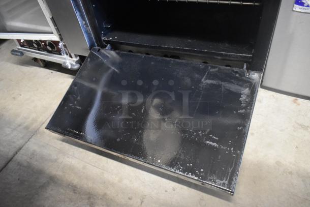 American Range stainless steel 6 burner range with oven, overshelf, backsplash, and casters. Used condition.