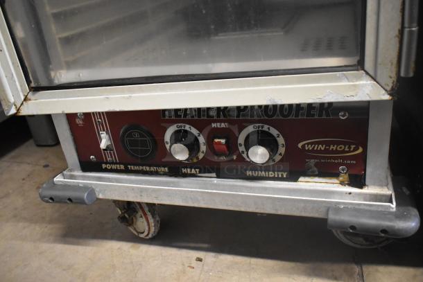 Win-holt metal heated holding cabinet, commercial casters, visible power controls. 115 volts, 1 phase. Used condition.