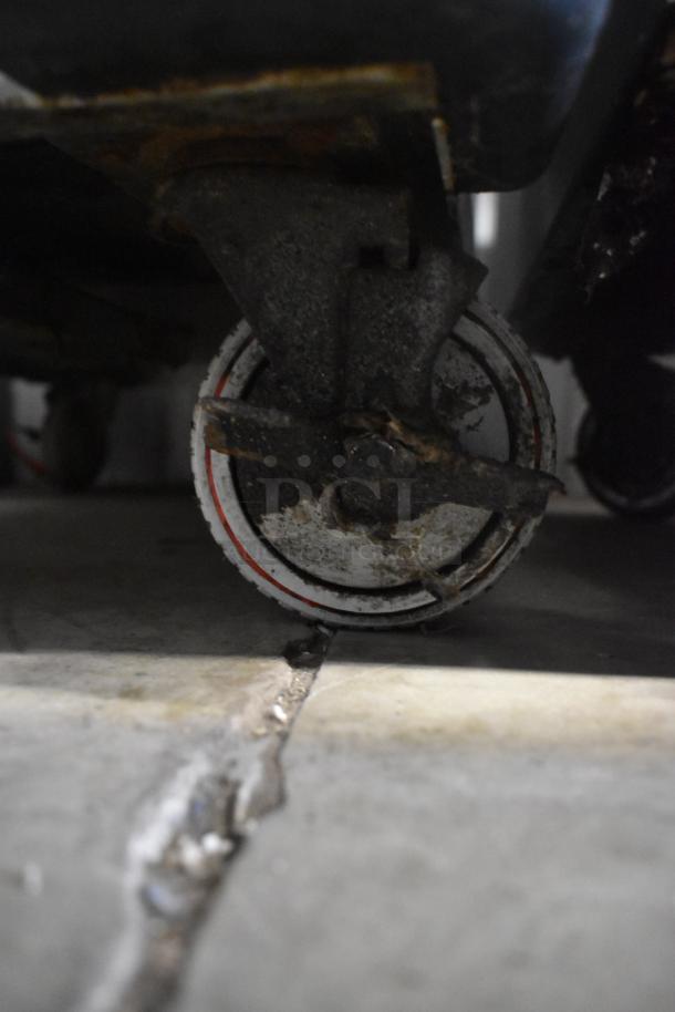 Win-holt commercial heated holding cabinet caster, showing wear and rust. 115 volts, 1 phase, metal construction.