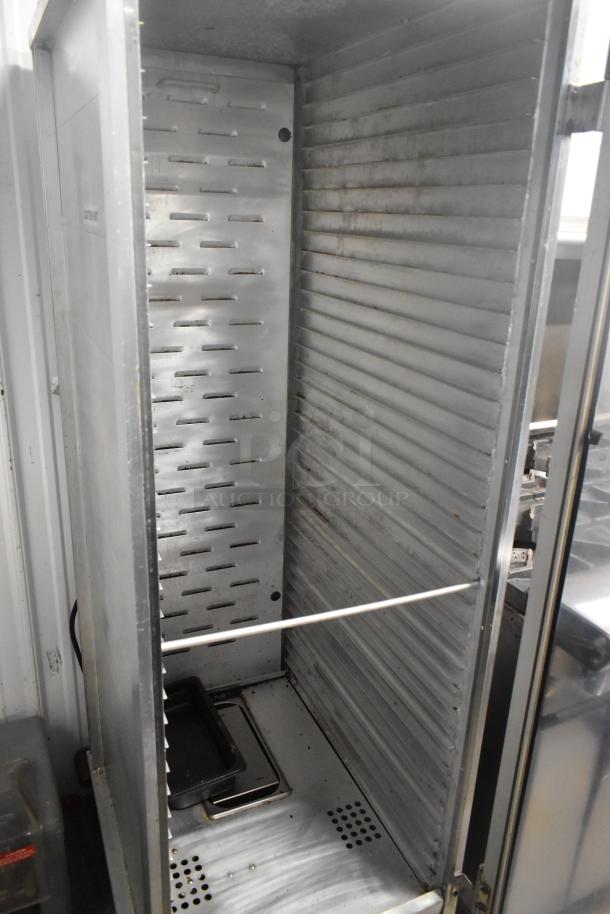 Win-holt metal commercial heated holding cabinet on casters, 115 volts, 1 phase. Features durable construction, has visible use marks.