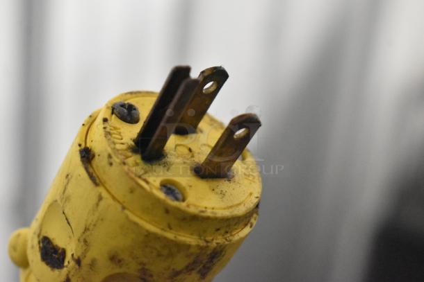 Yellow plug with three prongs, slightly tarnished, used for connecting Win-holt heated holding cabinet.