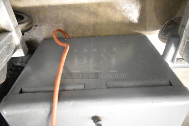 Metal commercial countertop electric meat tenderizer, 115 volts, 1 phase, visible orange cord, compact design.