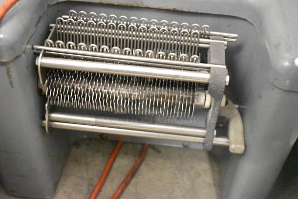 Metal commercial countertop electric meat tenderizer, 115 volts, 1 phase, visible rollers and blades, in used condition.