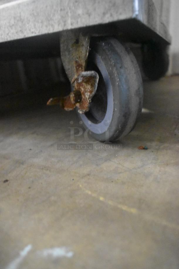 CresCor 118PH1834 heated holding cabinet caster, shows wear. Metal construction, commercial-grade, 120V, 1 phase.