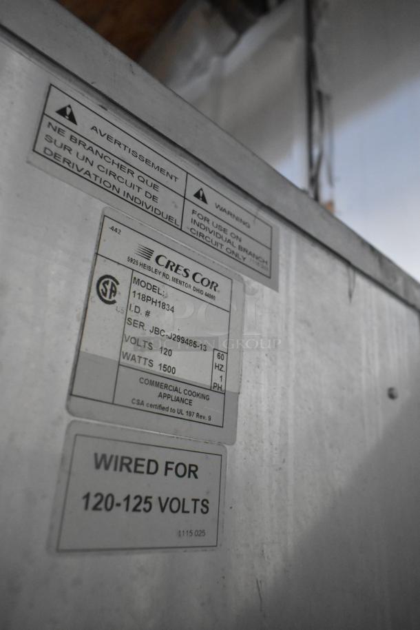 CresCor 118PH1834 heated holding cabinet, metal body on casters, 120V, 1 phase; labels indicate model and voltage specifications.