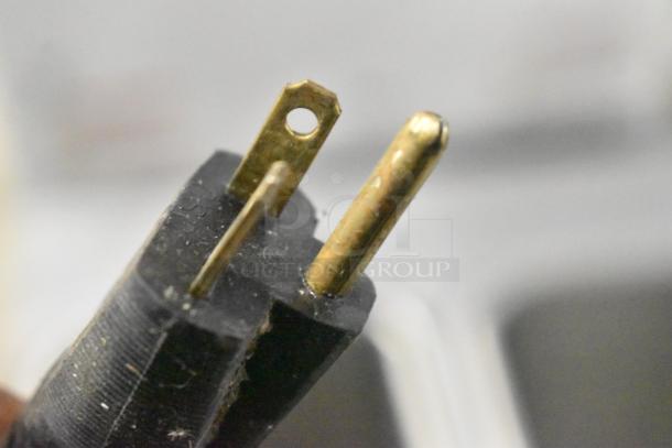Close-up of a power plug for the Stoelting F131-38I2 soft serve machine, showing three-prong design.