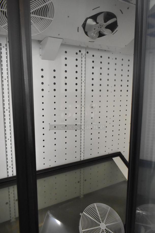 True FLM-81F 3 Door Reach-In Freezer, metal frame, poly-coated racks. 115V, 1 Phase, commercial use. Interior view.