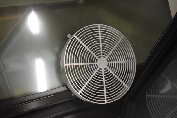 Vent cover of the 2025 True FLM-81F 3 Door Reach In Freezer Merchandiser. Made in metal, with poly coated racks.