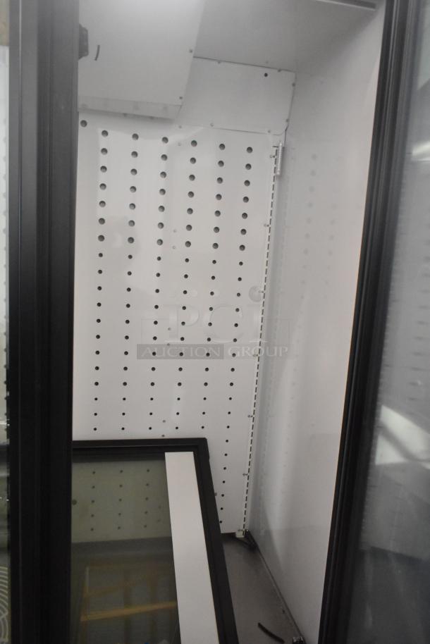 True FLM-81F 3-Door Freezer Merchandiser interior, showing poly-coated racks, perforated metal shelving, 115V, 1-phase.