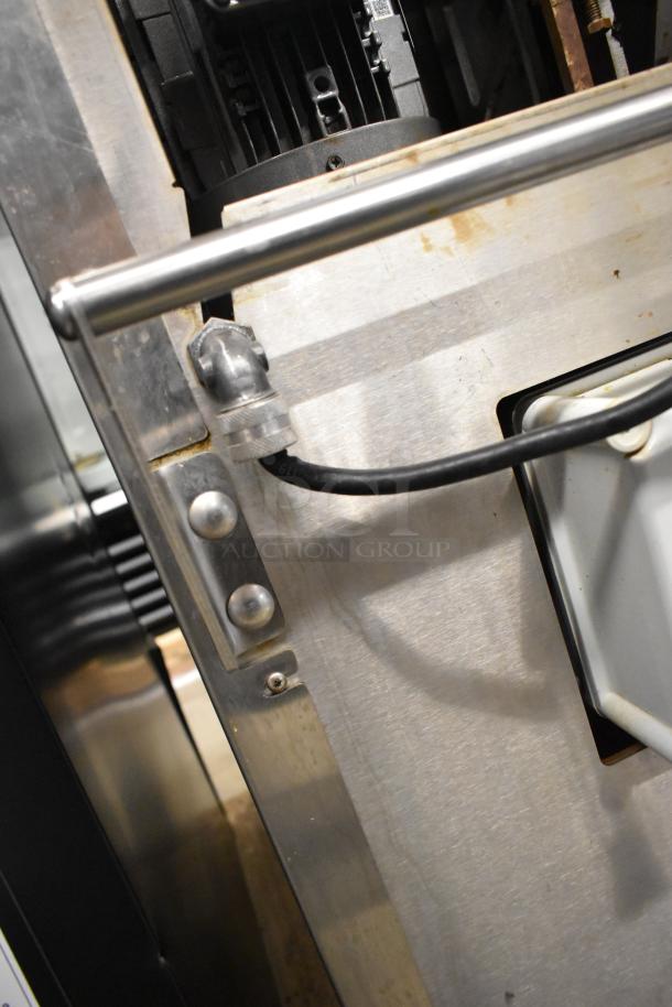 Stainless steel JBT 2ND-GEN-MFJ-HE citrus juicer, commercial floor style, on casters. 115V, single phase, fresh condition.