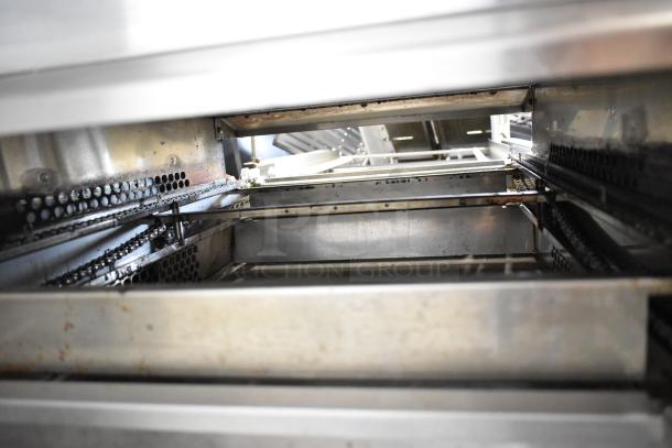 Belshaw Adamatic TG-50 stainless steel thermoglazing station in used condition, featuring commercial casters; 208V, 1 phase.