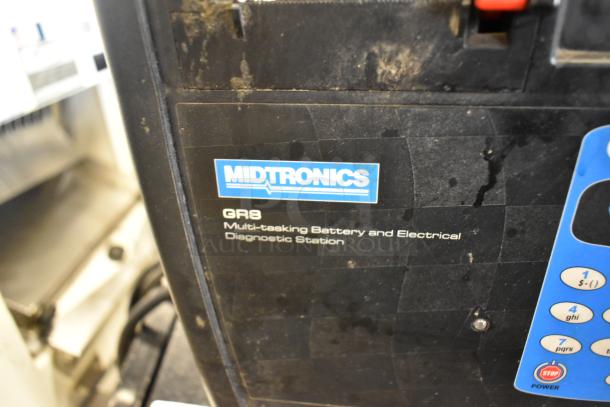 Midtronics GR8 diagnostic station, used condition, features battery and electrical testing; visible brand label and controls.