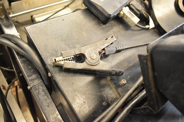 Midtronics GRB Battery Diagnostic Station, used, showing connectors and cables on a black metal base.