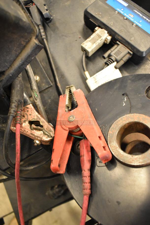 Midtronics GRB Diagnostic Station with red clamps, visible connectors, and cables. Used condition.