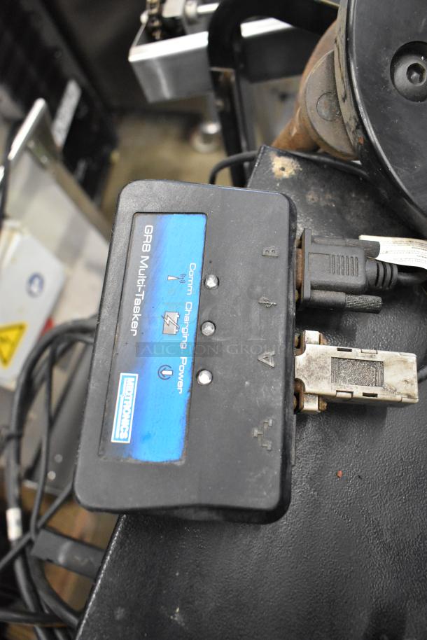 Midtronics GRB Multi-tasking Battery and Electrical Diagnostic Station with visible connectors and labels for Comm, Charging, and Power.
