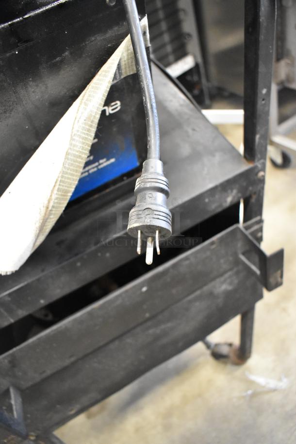 Midtronics GRB Battery and Electrical Diagnostic Station with visible power plug, showing signs of use.