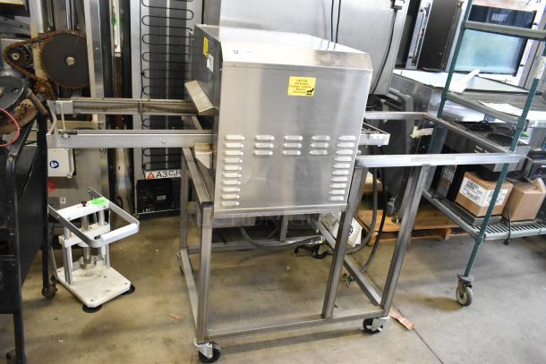 2018 Belshaw Adamatic TG50 stainless steel thermoglazing station on casters, 208V, 1 phase, with caution label.