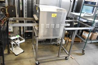 2018 Belshaw Adamatic TG50 stainless steel thermoglazing station on casters, 208V, 1 phase, with caution label.