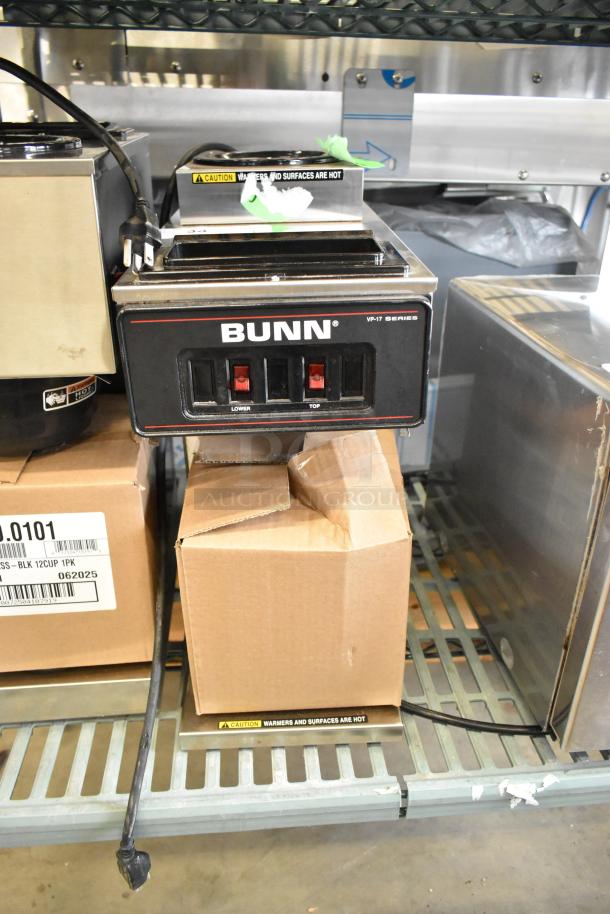 Brand new Bunn VP17-2 stainless steel coffee machine; 2 burners, 120V, slight cosmetic scratches. Caution label present.