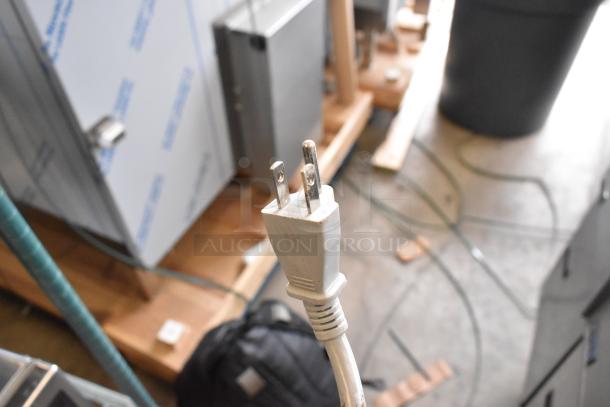 Alt text: Close-up of power plug for Amana RCS10TS stainless steel commercial microwave, 120 volts, slight scratches visible.