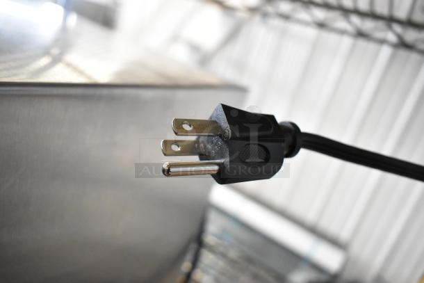 Power plug of Mainstays MS8436127995-01 Countertop Microwave, shiny metal prongs, black casing, for 120V, 1-phase.