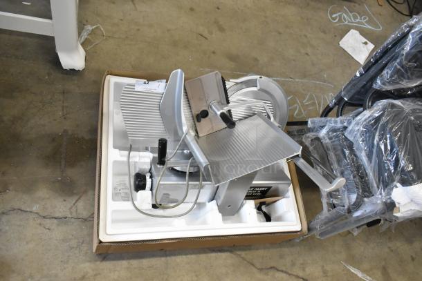 Bizerba commercial countertop meat slicer, 115 volts, 1 phase, in packaging. Excellent condition, includes power cord and safety label.