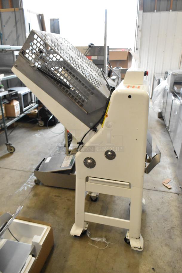 Oliver 797-32NC metal bread loaf slicer, commercial floor model, 115 volts, 1 phase, in warehouse setting.