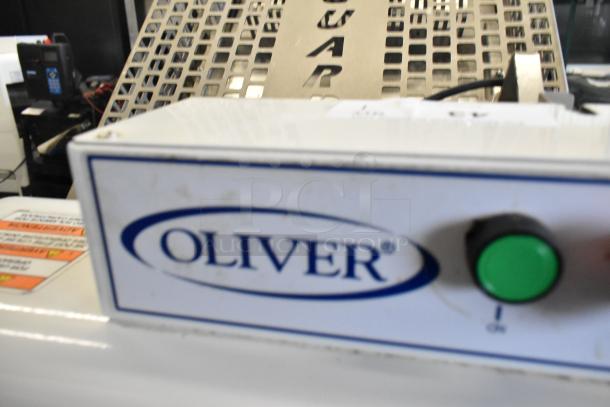 Oliver 797-32NC metal bread loaf slicer, commercial floor model, 115 volts, 1 phase, good condition, control panel with green button.