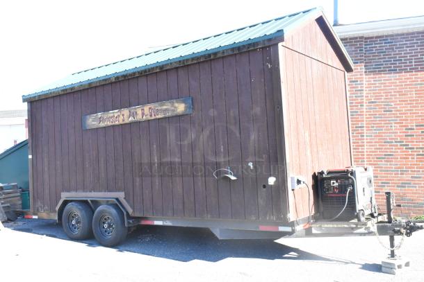 Fully outfitted food trailer, dark wood exterior, Predator generator, equipped with commercial kitchen for mobile use.