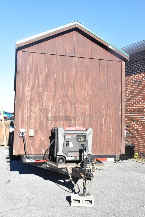 Mobile food trailer with wood exterior, equipped with Predator generator. Ready for use as a commercial kitchen. Clear title included.