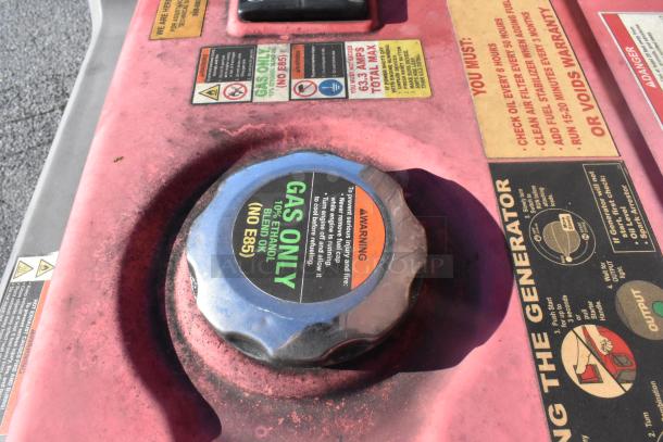 Gasoline generator cap with label indicating "Gas Only" and maintenance instructions in a fully outfitted food trailer.