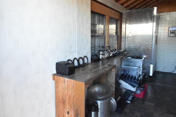 Fully equipped food trailer interior with commercial appliances, cabinets, and tools. Includes Avantco cooler and steam table.