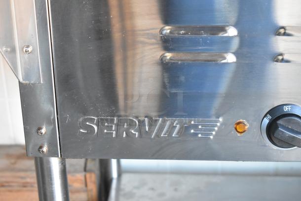 ServIt steam table close-up, showing metal finish, logo, and control knob, part of fully outfitted food trailer kitchen.