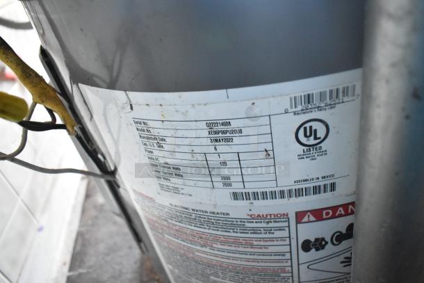 Label on a tank water heater; serial: Q222214608, model: XE06P06PU20U0, date: 31 May 2022, capacity: 6 gal.