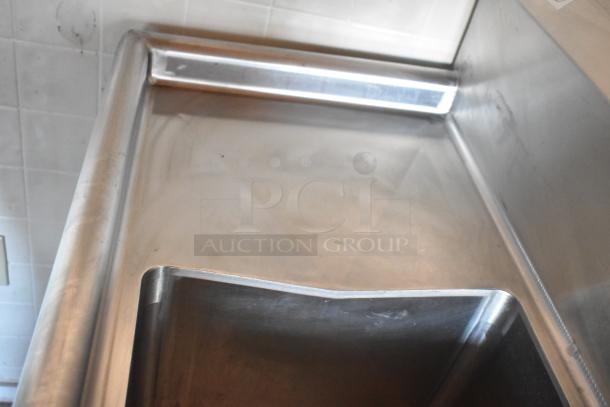 Stainless steel sink and countertop in a mobile kitchen food trailer, showcasing clean, commercial-grade equipment conditions.