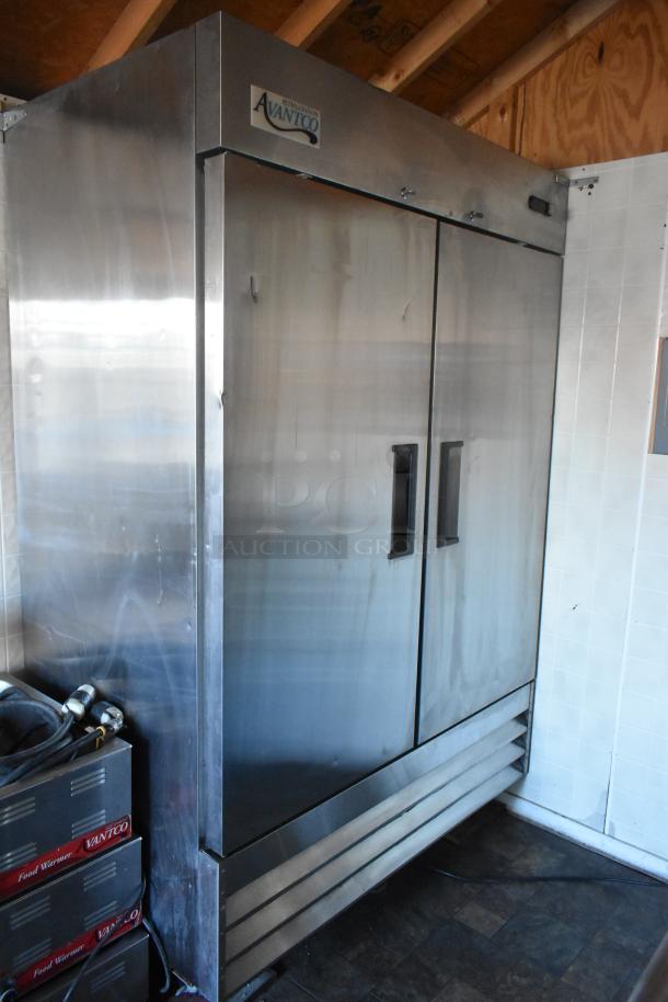Avantco reach-in cooler inside a fully equipped food trailer, featuring durable stainless steel construction.
