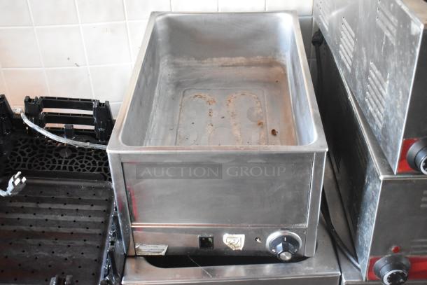 Commercial food warmer with control knob, part of a fully outfitted mobile kitchen. Stainless steel, used condition.