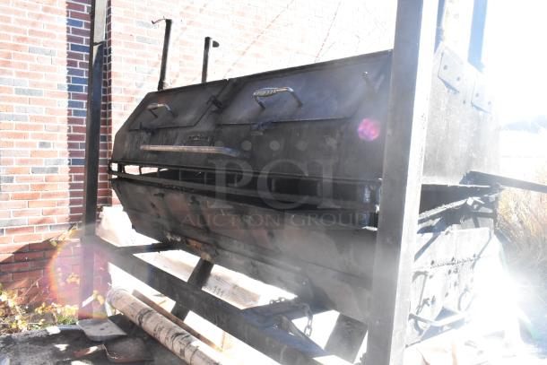 Outdoor Meadow Creek barbecue grill with dual lids and metal frame, showing signs of heavy use.