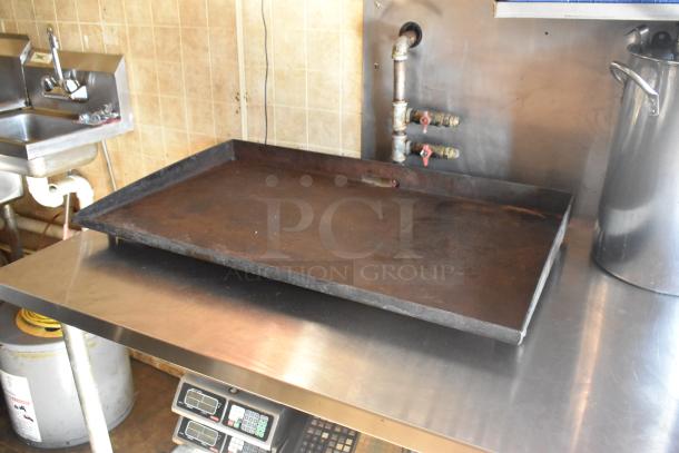 Interior of 2007 Lanchester food trailer, featuring a commercial-grade stainless steel counter with kitchen fixtures.