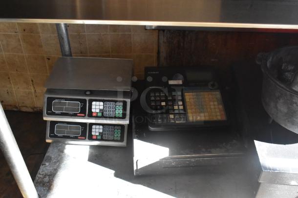 Digital Torrey scales and Casio cash register inside 2007 Lanchester food trailer, showing commercial setup.